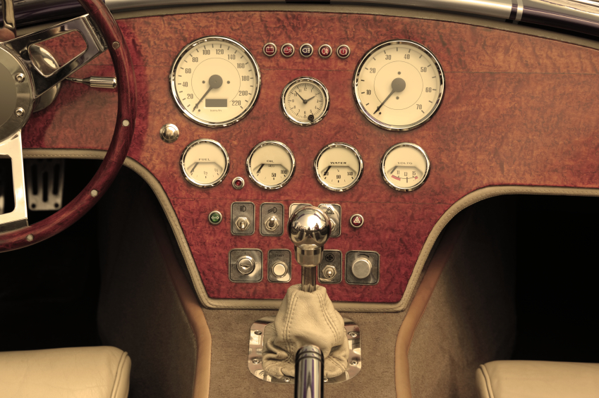 buttons and dials on dashboard of vintage car