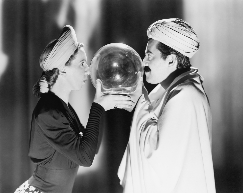 man and woman with faces pressed against crystal ball