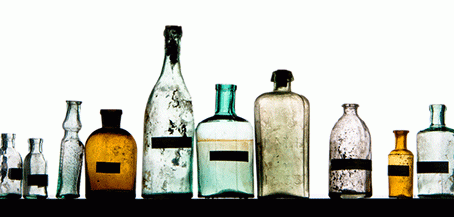 row of bottles with coloured liquid